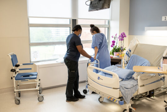 patient standing with occupational therapist